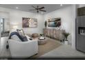 Comfortable living room featuring neutral decor, stylish furnishings, and contemporary entertainment center at 875 Apatite Pl # Lot 55, Henderson, NV 89011