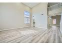 Bright living room with hardwood floors, soaring ceilings, large windows and neutral paint scheme at 9272 W Viking Rd, Las Vegas, NV 89147