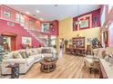Spacious living room featuring soaring ceilings, an open floor plan, and hardwood floors at 9378 Chateau St Jean Dr, Las Vegas, NV 89123