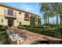Mediterranean-style home with front stone bench and manicured garden at 9940 Orient Express Ct, Las Vegas, NV 89145
