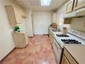 Cozy kitchen featuring essential appliances and a bright skylight for natural lighting at 10101 Hemet Dr, Las Vegas, NV 89134
