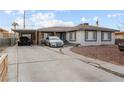 Charming single-story home featuring a spacious driveway and covered parking at 1100 H St, Las Vegas, NV 89106