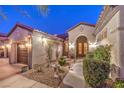 Front entrance featuring elegant double doors, manicured bushes, and desert landscaping at 1809 Prichard Ave, Henderson, NV 89052