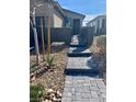 Charming front entrance with stone pavers and desert landscaping leading to a cozy home at 2379 Albury Ave, North Las Vegas, NV 89086