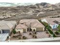 An aerial view of the home showcases the desert landscaping, tile roof, and attached garages at 2388 Orangeburg Pl, Henderson, NV 89044