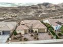 Stunning aerial view captures the home's tile roof, desert landscaping, and mountain backdrop at 2388 Orangeburg Pl, Henderson, NV 89044