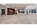 Bright living room features a fireplace, built-in shelving, large windows, and light wood-look flooring at 2388 Orangeburg Pl, Henderson, NV 89044