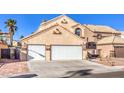 Inviting two-story home with a two-car garage, tile roof, and desert landscaping at 4125 Glenfield Cir, Las Vegas, NV 89129