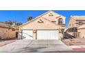 Charming two-story stucco home featuring a two-car garage and easy-care desert landscaping at 4125 Glenfield Cir, Las Vegas, NV 89129