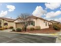 Low angle view of single-story home with landscaped yard and brown shutters against a bright, cloudy sky at 4459 Lavender, Pahrump, NV 89061