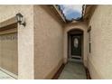 Inviting front entrance featuring textured walls, arched doorway and a dark, elegant front door at 4459 Lavender, Pahrump, NV 89061