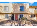 View of townhome featuring a stucco exterior with a well maintained yard at 466 Las Casitas Way, Las Vegas, NV 89121