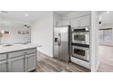 Modern kitchen showcasing stainless steel appliances, sleek countertops and stylish tile flooring at 4905 Madre Maria Ct, North Las Vegas, NV 89031