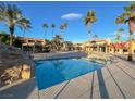Luxury resort-style pool surrounded by palm trees and sundeck at 5422 River Glen Dr # 373, Las Vegas, NV 89103