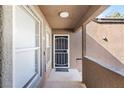 Covered entryway with a secure front door and white framed windows at 555 E Silverado Ranch Blvd # 2114, Las Vegas, NV 89183