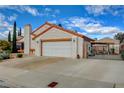 Attractive single-story home with low maintenance landscaping and convenient attached two-car garage at 630 Otono Dr, Boulder City, NV 89005