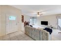 Spacious living room with tile entry, fireplace, ceiling fan, and sliding glass doors at 630 Otono Dr, Boulder City, NV 89005