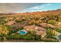 A home with a sparkling pool, beautiful landscaping and mountain views at 71 Fountainhead Cir, Henderson, NV 89052