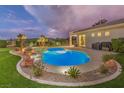 Backyard pool featuring lush landscaping and ample space for outdoor entertaining at 71 Fountainhead Cir, Henderson, NV 89052