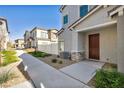 Attractive townhome exterior highlighting neat landscaping, a stone-accented facade, and a tidy walkway at 7348 N Decatur Blvd # 5, Las Vegas, NV 89131