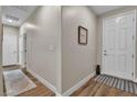 Inviting hallway with wood-look flooring and neutral paint, leading to various rooms at 741 Monroe Hill Pl, Henderson, NV 89011