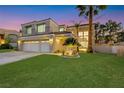 Well maintained two-story home featuring a three-car garage and manicured lawn at 9 Cozy Glen Cir, Henderson, NV 89074