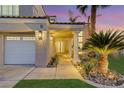 Inviting front entrance with double doors, manicured landscaping, and a three-car garage at 9 Cozy Glen Cir, Henderson, NV 89074