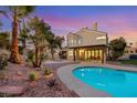 Backyard pool featuring desert landscaping and covered patio perfect for outdoor enjoyment at 9 Cozy Glen Cir, Henderson, NV 89074