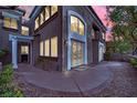 Stunning home exterior with arched windows, manicured landscaping and a curved walkway at 9425 San Laguna Ct # 102, Las Vegas, NV 89134