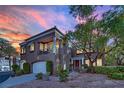 Attractive exterior view of home with balcony, mature trees, and manicured shrubs at 9425 San Laguna Ct # 102, Las Vegas, NV 89134