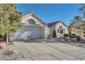 A well-maintained house with a stone accented, low maintenance front yard and driveway at 9704 Brawley Dr, Las Vegas, NV 89134