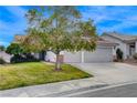 Beautiful home with well-manicured lawn and spacious two-car garage, perfect for suburban living at 1107 Cloudy Day Dr, Henderson, NV 89074