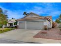 Charming single-story home featuring a spacious two-car garage and low maintenance landscaping at 1107 Cloudy Day Dr, Henderson, NV 89074