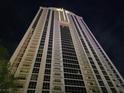 Striking upward view of a modern high-rise residential building at night showing architectural details and lighting at 135 E Harmon Ave # 2120, Las Vegas, NV 89109