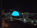 Night view of a brightly illuminated entertainment facility with a glowing dome against the Las Vegas skyline at 135 E Harmon Ave # 2120, Las Vegas, NV 89109