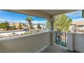 Covered patio view looking out at desert landscaping, mountains, and a sunny street at 1412 Oak Rock Dr # 202, Las Vegas, NV 89128
