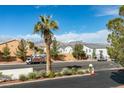 Neighborhood street view with desert landscaping, and a mountain backdrop on a sunny day at 1412 Oak Rock Dr # 202, Las Vegas, NV 89128