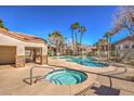 Community pool and hot tub area with well-maintained landscaping and clear blue sky at 2101 Sealion Dr # 105, Las Vegas, NV 89128