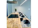 Close-up of kitchen island with cooktop and place settings with tableware at 2250 Red Rock St, Las Vegas, NV 89146