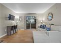 Spacious living room with a large sectional couch, a large glass sliding door, and hardwood flooring at 2300 E Silverado Ranch Blvd # 1059, Las Vegas, NV 89183