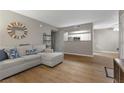 Open-concept living room with view of the kitchen through a pass through, hardwood floors and neutral colors at 2300 E Silverado Ranch Blvd # 1059, Las Vegas, NV 89183
