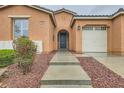 Charming single-story home with landscaped entry, covered porch and warm neutral tones at 6065 Burleson Ranch Rd, Las Vegas, NV 89131