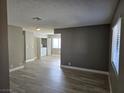 Living room with wood-look tile, fresh paint, laundry closet and ample natural light at 6743 W Charleston Blvd # 4, Las Vegas, NV 89146