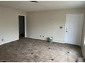 An inviting living room featuring tile flooring and a bright white entry door at 7046 Royal Meadow Pl, Las Vegas, NV 89147