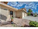 Inviting front entrance with a beautiful stone walkway and lush landscaping leading to a well-maintained home at 7724 Clearwood Ave, Las Vegas, NV 89123