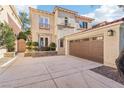 A charming two-story home featuring a brown garage door, tiled roof, and landscaped front yard at 9044 Opus Dr, Las Vegas, NV 89117