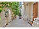 Charming walkway features stone accents, lush greenery, and a striking lion head fountain at 9044 Opus Dr, Las Vegas, NV 89117