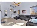 Open living room showcasing tile floors, a large sectional sofa, and plenty of natural light at 9417 Grenville Ave, Las Vegas, NV 89134