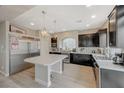 Bright kitchen featuring stainless steel appliances, dark cabinetry, and white countertops at 9835 Fox Estate St, Las Vegas, NV 89141