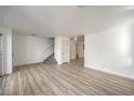 Spacious living room featuring wood-look floors and a staircase leading to the second floor at , Las Vegas, NV 89118